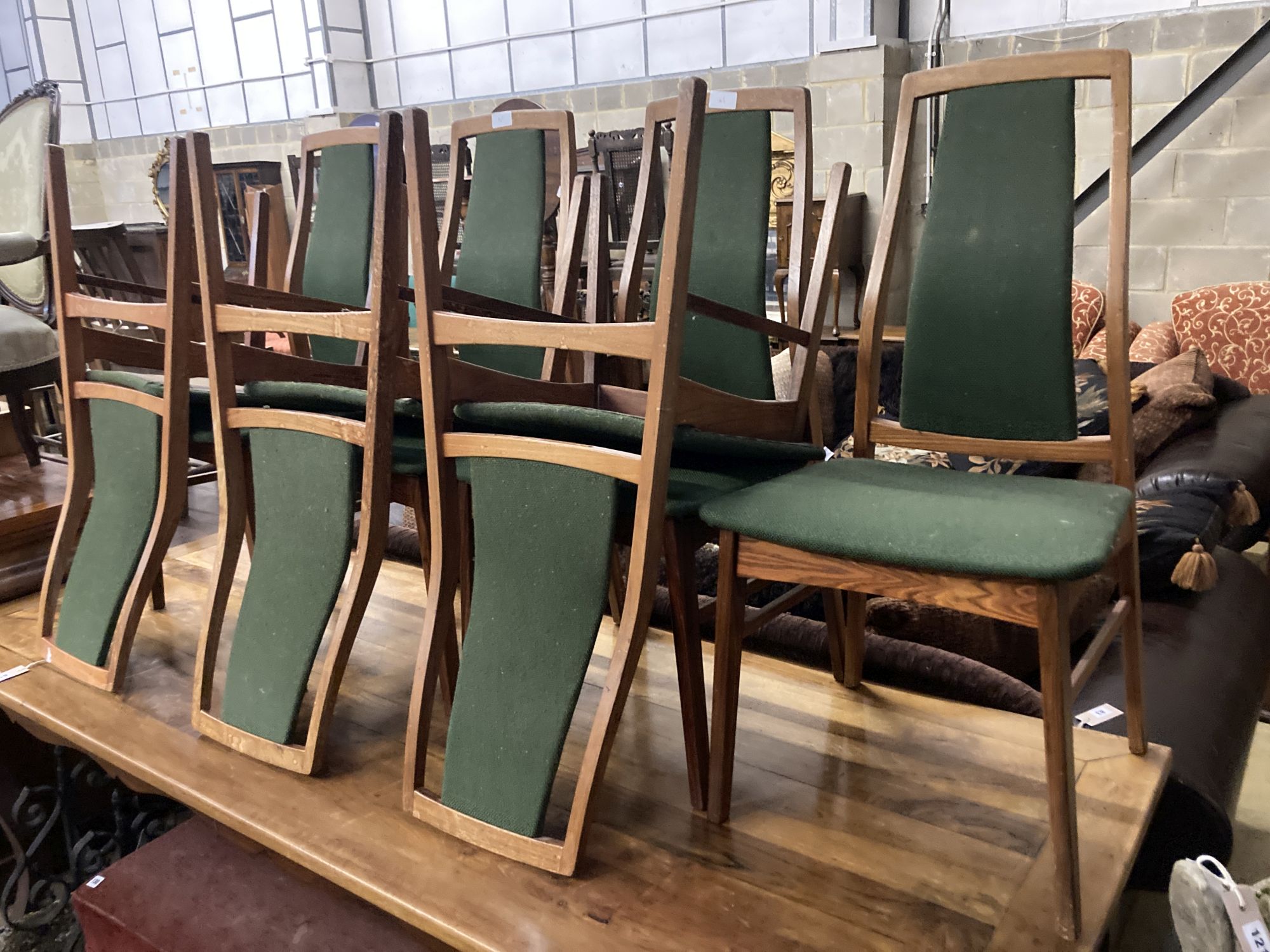 A set of eight mid century design Danish teak high back dining chairs